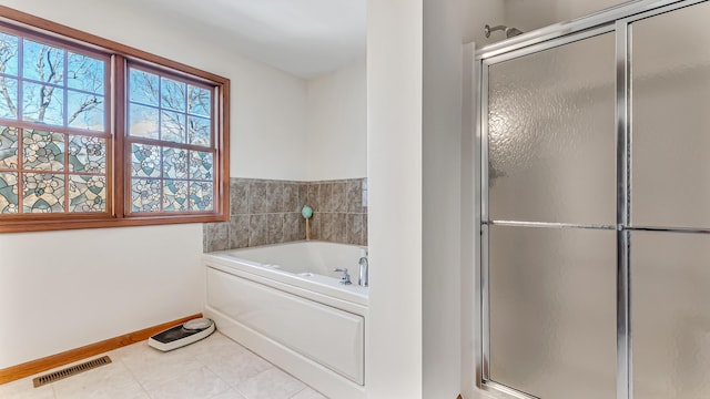 full bath featuring a stall shower, visible vents, baseboards, a garden tub, and tile patterned flooring