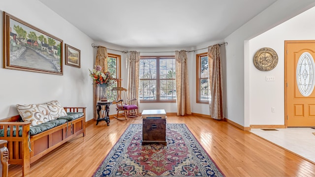 entryway with light wood-style flooring and baseboards