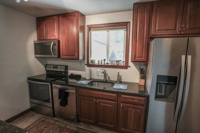 569 Lafayette Ave, Palmerton, PA 18071 - kitchen with appliances with stainless steel finishes, dark stone counters, and tile patterned flooring