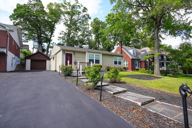 569 Lafayette Ave, Palmerton, PA 18071 - view of front of home with a detached garage, an outbuilding, and a front lawn