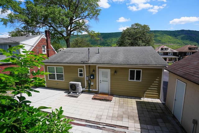 569 Lafayette Ave, Palmerton, PA 18071 - back of property with a patio area, a shingled roof, and a mountain view