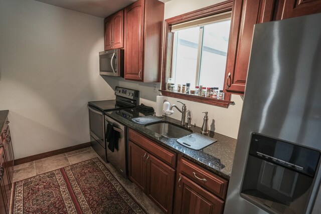 569 Lafayette Ave, Palmerton, PA 18071 - kitchen with stainless steel appliances, dark stone counters, and reddish brown cabinets