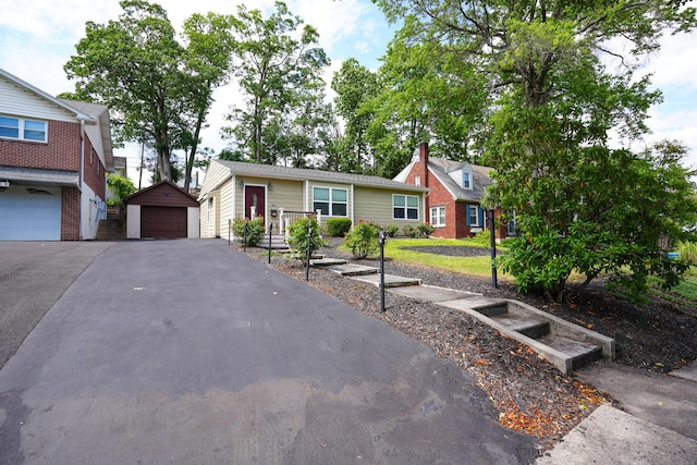 569 Lafayette Ave, Palmerton, PA 18071 - view of front of property with a garage, an outbuilding, and a chimney