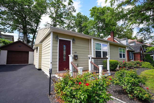 569 Lafayette Ave, Palmerton, PA 18071 - view of front facade featuring a detached garage, an outbuilding, and a chimney