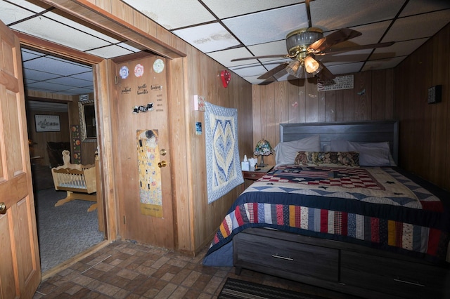 3193 Pine Ridge Dr, Bushkill, PA 18324 - bedroom featuring a paneled ceiling, brick patterned floor, and wood walls