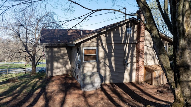 3193 Pine Ridge Dr, Bushkill, PA 18324 - view of property exterior with a chimney and fence