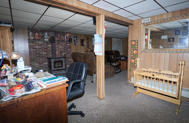 3193 Pine Ridge Dr, Bushkill, PA 18324 - carpeted home office featuring a drop ceiling, a wood stove, and wood walls