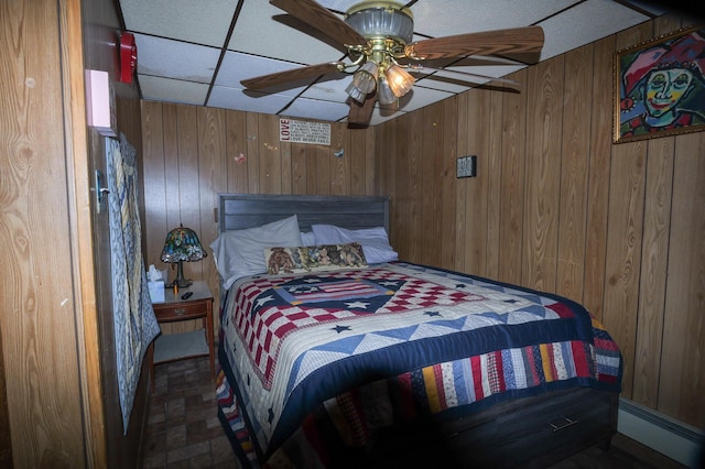 3193 Pine Ridge Dr, Bushkill, PA 18324 - bedroom with wood walls, a baseboard radiator, and a ceiling fan