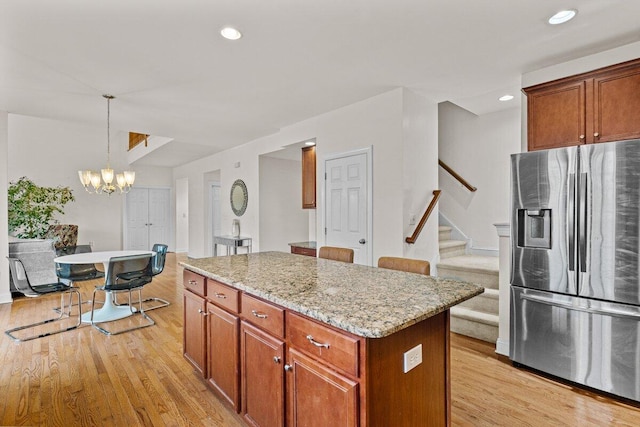 255 Rising Meadow Way E, Stroudsburg, PA 18302 - kitchen featuring stainless steel fridge with ice dispenser, light wood finished floors, a kitchen island, a chandelier, and recessed lighting