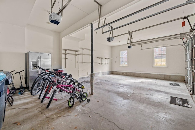 255 Rising Meadow Way E, Stroudsburg, PA 18302 - garage with stainless steel fridge and a garage door opener
