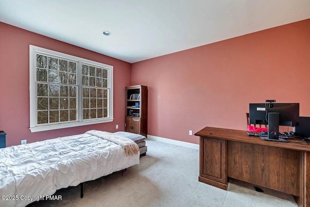 bedroom featuring light carpet and baseboards