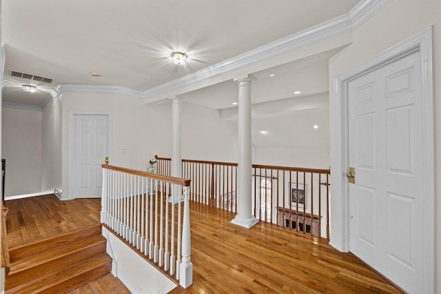 255 Rising Meadow Way E, Stroudsburg, PA 18302 - hallway with ornate columns, wood finished floors, an upstairs landing, and crown molding