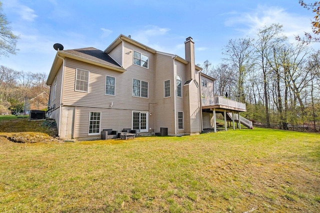 255 Rising Meadow Way E, Stroudsburg, PA 18302 - back of house with stairs, a chimney, a lawn, and a wooden deck