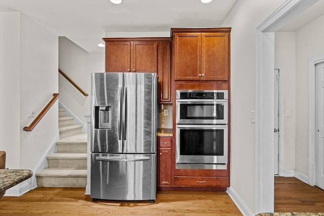 255 Rising Meadow Way E, Stroudsburg, PA 18302 - kitchen featuring stainless steel appliances, light wood-style floors, brown cabinets, and recessed lighting