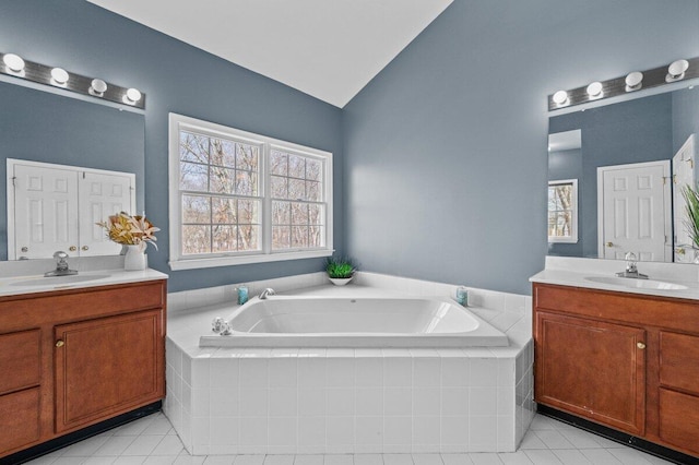 255 Rising Meadow Way E, Stroudsburg, PA 18302 - bathroom featuring two vanities, lofted ceiling, tile patterned flooring, and a garden tub