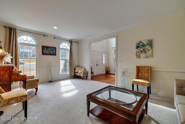 living room featuring recessed lighting, baseboards, crown molding, and carpet flooring