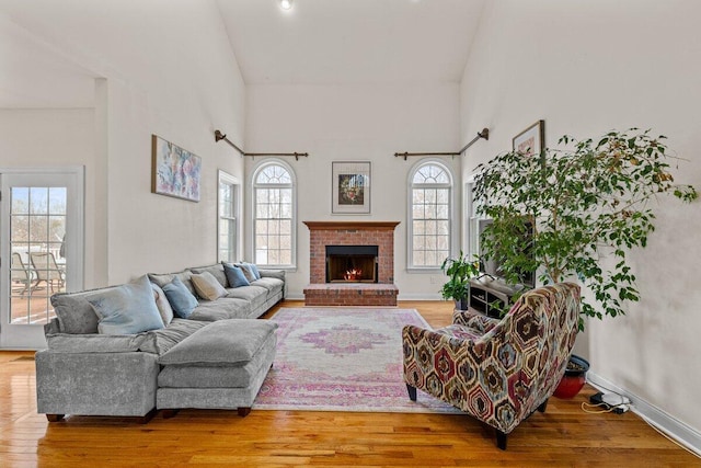255 Rising Meadow Way E, Stroudsburg, PA 18302 - living room with wood finished floors, a brick fireplace, and a high ceiling