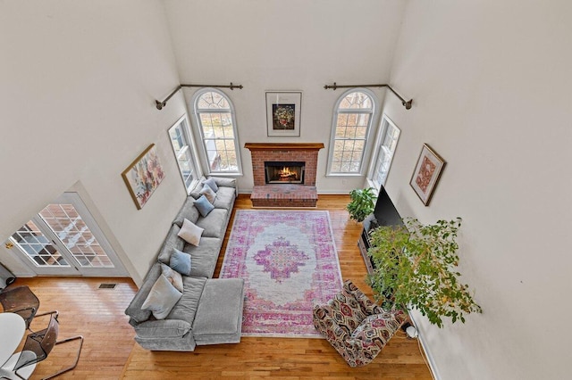 255 Rising Meadow Way E, Stroudsburg, PA 18302 - living area featuring plenty of natural light, a towering ceiling, wood finished floors, and a fireplace