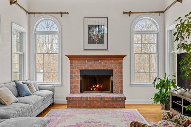 255 Rising Meadow Way E, Stroudsburg, PA 18302 - living area with plenty of natural light, wood finished floors, and a fireplace