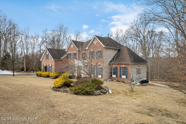 view of front of house with a front yard and brick siding