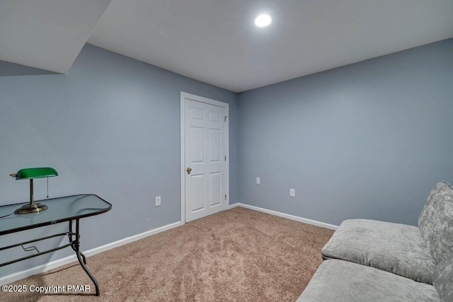 sitting room featuring carpet floors and baseboards