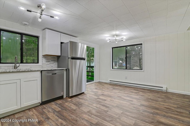 kitchen featuring a baseboard heating unit, a sink, white cabinets, appliances with stainless steel finishes, and dark wood-style floors