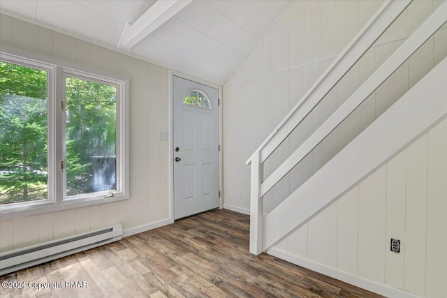 foyer entrance featuring vaulted ceiling, baseboards, baseboard heating, and wood finished floors