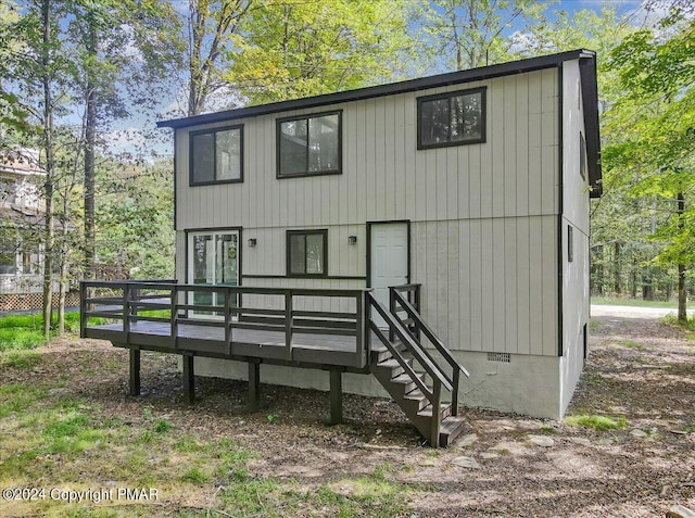 back of property featuring french doors and a wooden deck