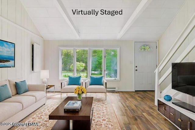 living room featuring a baseboard radiator, vaulted ceiling with beams, and wood finished floors