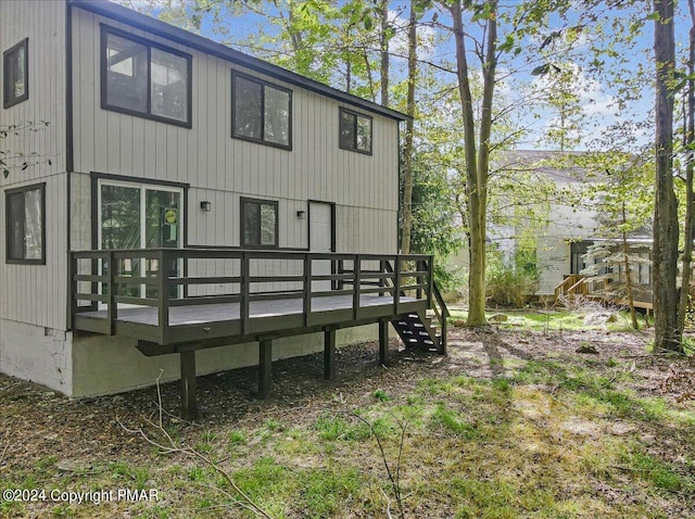 back of property with a wooden deck