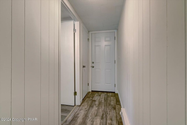 hallway with baseboards and wood finished floors