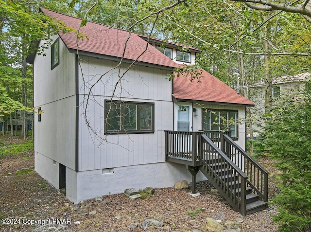 view of front of home featuring a shingled roof and crawl space