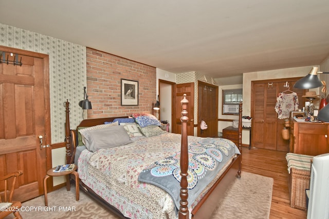 4462 Woodside Dr, East Stroudsburg, PA 18301 - bedroom featuring two closets, wallpapered walls, and wood finished floors