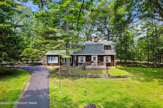 4462 Woodside Dr, East Stroudsburg, PA 18301 - dutch colonial featuring a chimney, roof with shingles, asphalt driveway, a front lawn, and a wooden deck