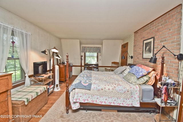 4462 Woodside Dr, East Stroudsburg, PA 18301 - bedroom with wood finished floors and brick wall