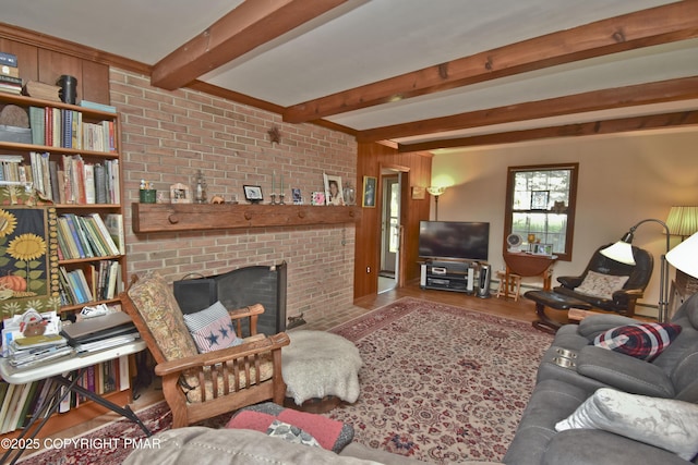 4462 Woodside Dr, East Stroudsburg, PA 18301 - living room with beamed ceiling, wood finished floors, and a brick fireplace