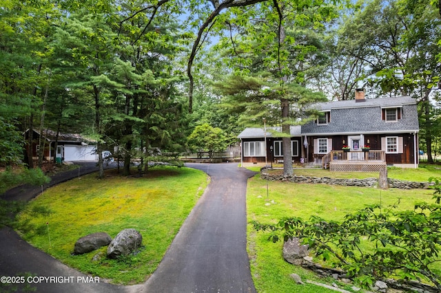 4462 Woodside Dr, East Stroudsburg, PA 18301 - view of front of home featuring a chimney, a shingled roof, driveway, a gambrel roof, and a wooden deck