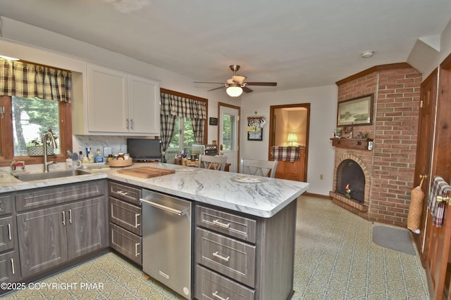 4462 Woodside Dr, East Stroudsburg, PA 18301 - kitchen with plenty of natural light, stainless steel dishwasher, a peninsula, and white cabinetry