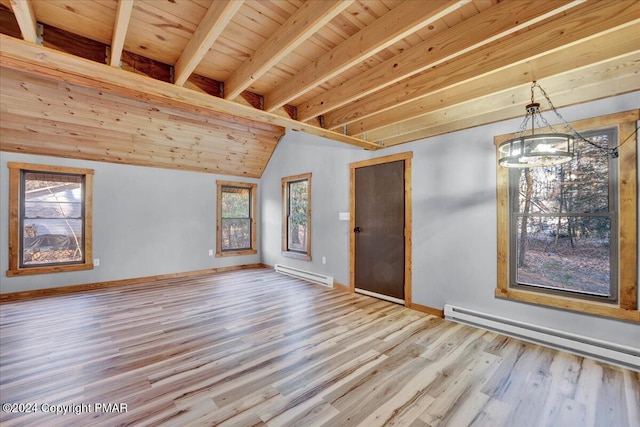 interior space with baseboards, baseboard heating, and wood finished floors