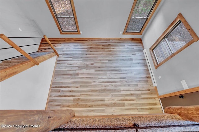 unfurnished living room featuring plenty of natural light and wood finished floors