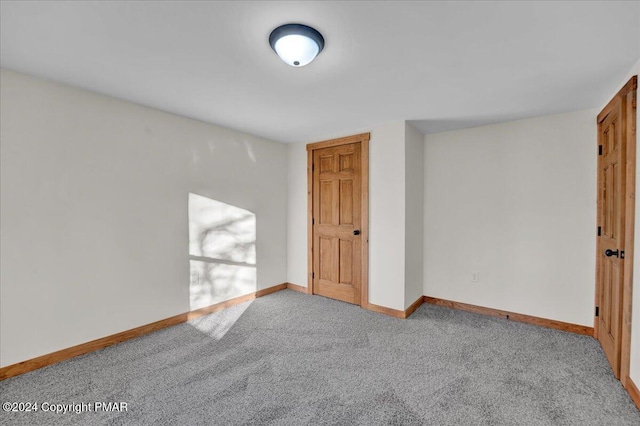 spare room with carpet floors and baseboards