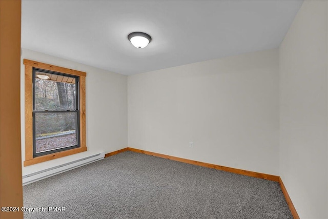 empty room featuring a baseboard radiator, carpet flooring, and baseboards