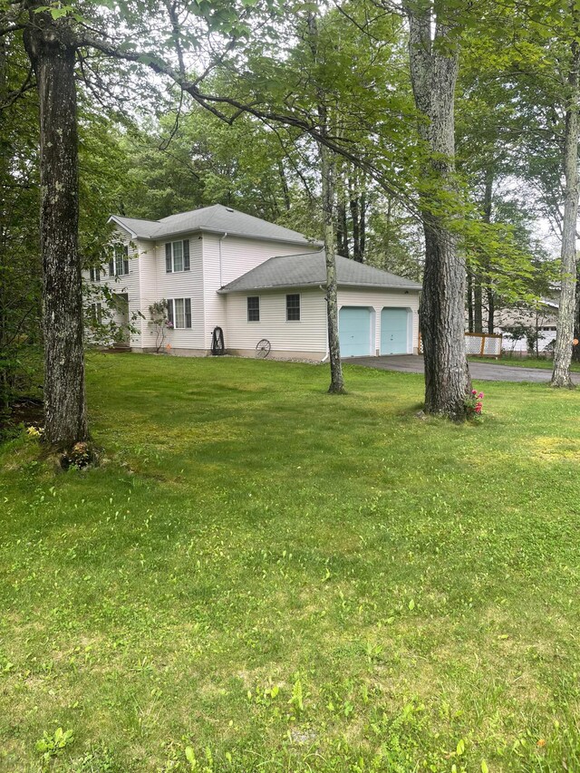 2852 Oak View Ln, Tobyhanna, PA 18466 - back of property with a yard, asphalt driveway, and an attached garage