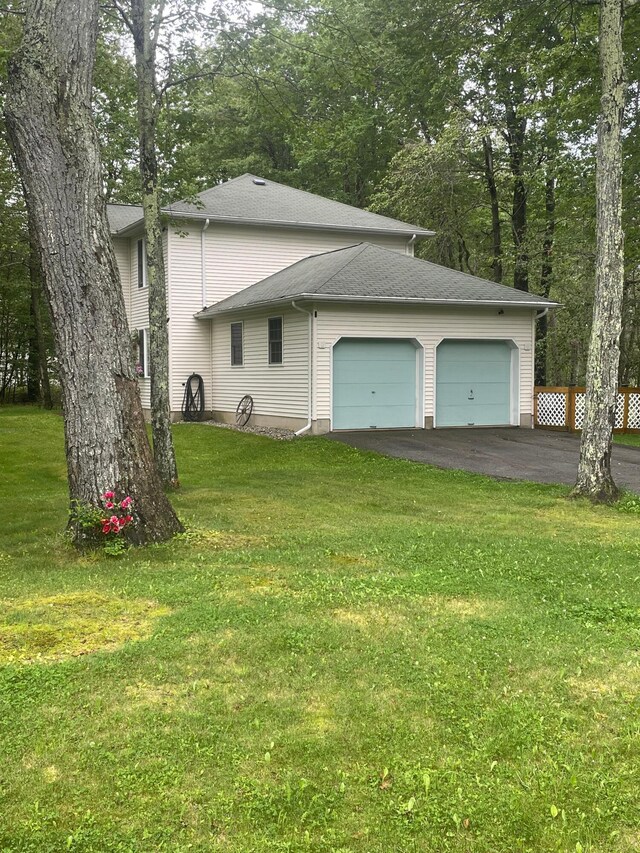 2852 Oak View Ln, Tobyhanna, PA 18466 - view of home's exterior with an attached garage, asphalt driveway, a yard, and roof with shingles