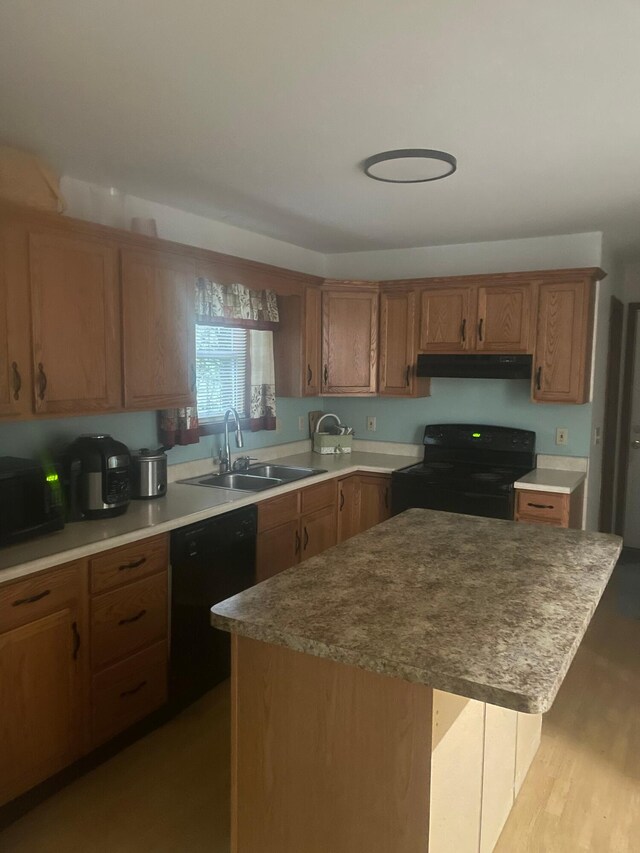 2852 Oak View Ln, Tobyhanna, PA 18466 - kitchen with black appliances, under cabinet range hood, a kitchen island, and brown cabinetry