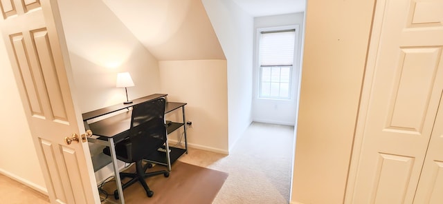 office space with carpet floors, baseboards, and vaulted ceiling