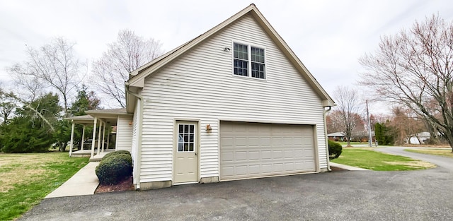 garage featuring asphalt driveway