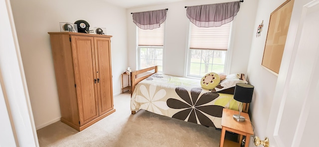 bedroom featuring carpet floors and baseboards