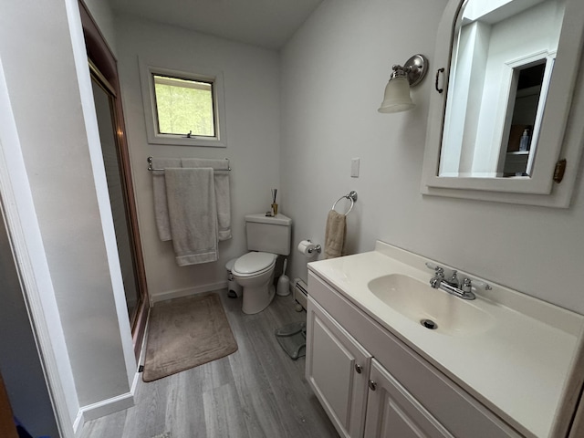 462 Plane St, Weatherly, PA 18255 - bathroom featuring wood finished floors, vanity, toilet, a stall shower, and baseboard heating