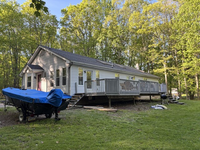 462 Plane St, Weatherly, PA 18255 - back of property featuring a deck, a yard, view of wooded area, and a shingled roof